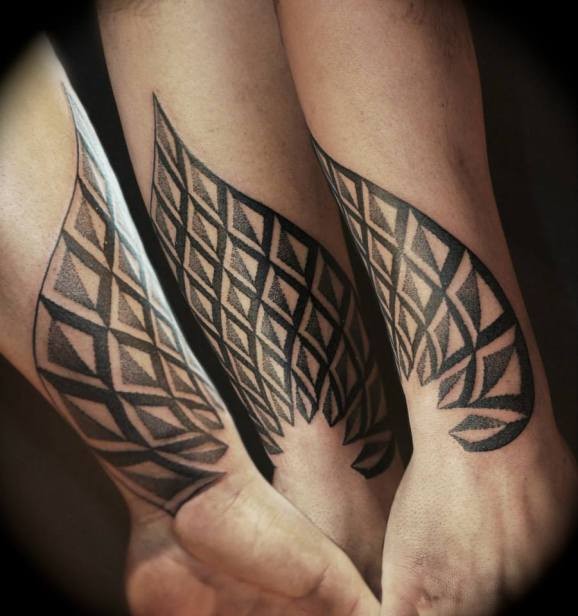 Original geometric wing style tattoo on wrist by Joe Munroe