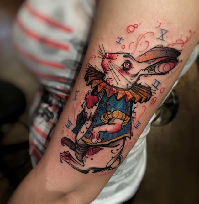 Original homemade like colored fantasy rabbit tattoo on arm with multicolored numbers