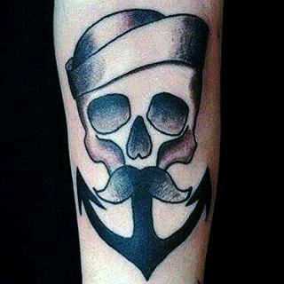 Original painted black and white sailor skull with anchor tattoo on forearm