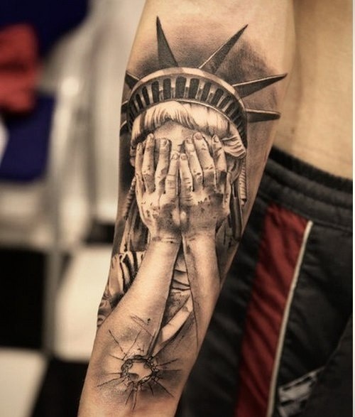 Original styled very realistic Statue of Liberty tattoo on arm