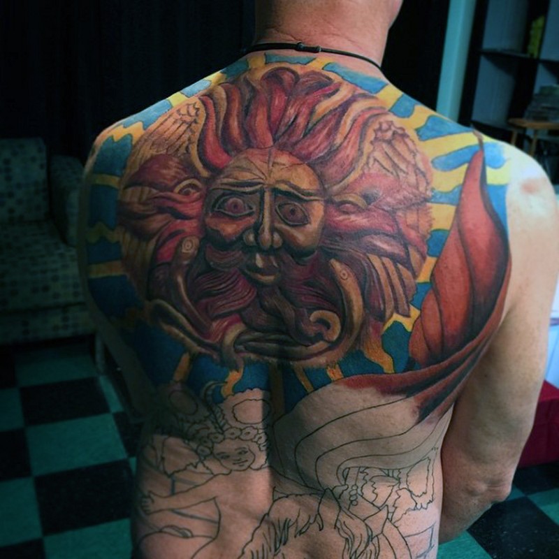 Original tribal style colored big sun tattoo on upper back