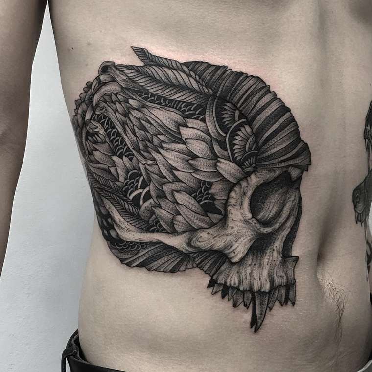 Ornamental style black ink mystical skull tattoo on belly