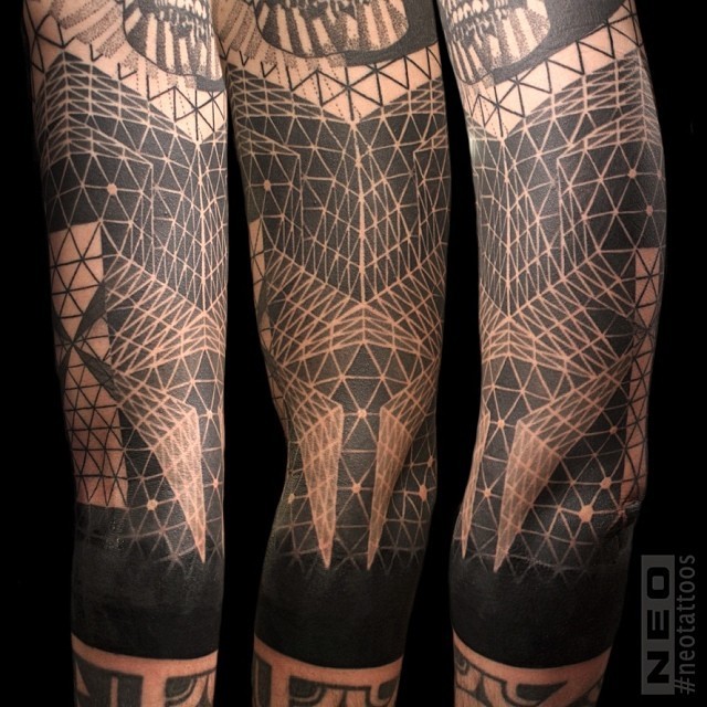Ornamental style colored arm tattoo of various geometrical figures