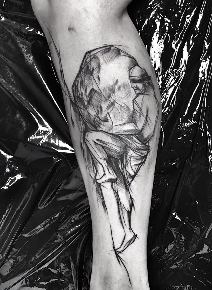 Painted by Inez Janiak tattoo of man with big rock