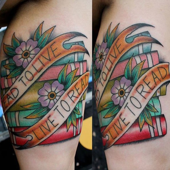 Pale of colored thick books decorated with banner lettering and flowers tattoo