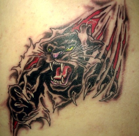 Black panther under skin rip tattoo on shoulder blade