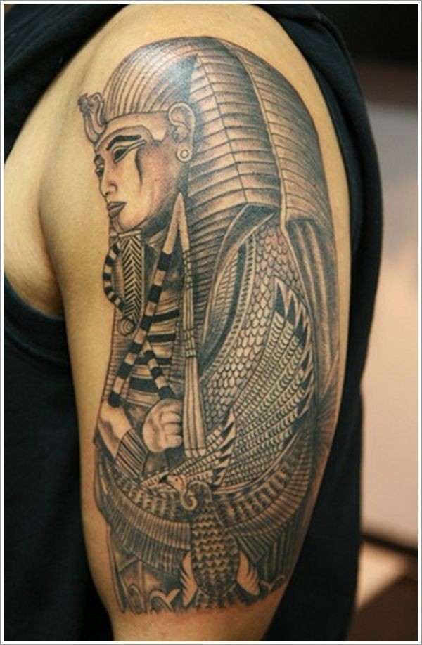 Pharaoh with power symbols tattoo on arm
