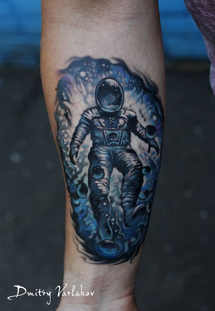 Photoshop style colored forearm tattoo of spaceman