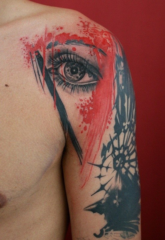 Photoshop style colored shoulder tattoo of woman eye