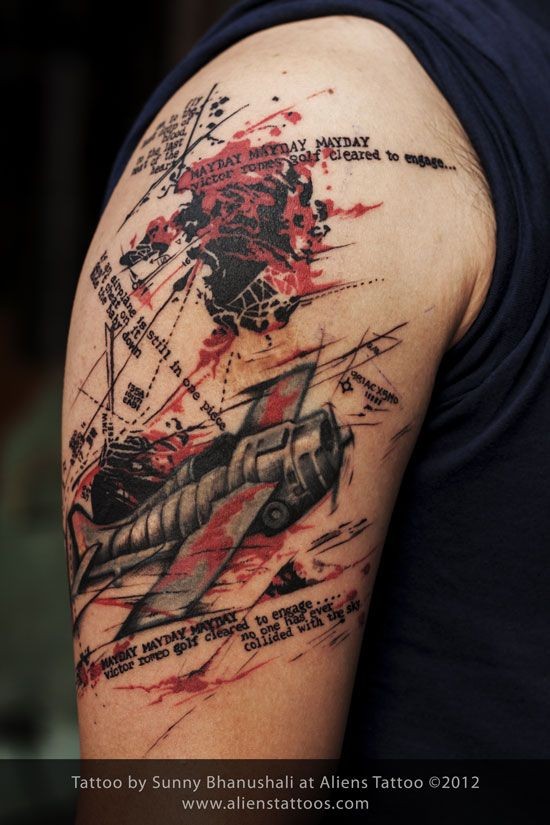 Photoshop style colored shoulder tattoo of flying plane with lettering