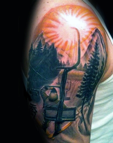 Picture style colored shoulder tattoo of man with sun and mountain