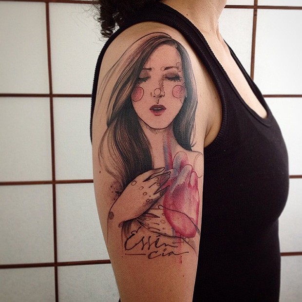 Picture style colored shoulder tattoo of woman with heart and lettering