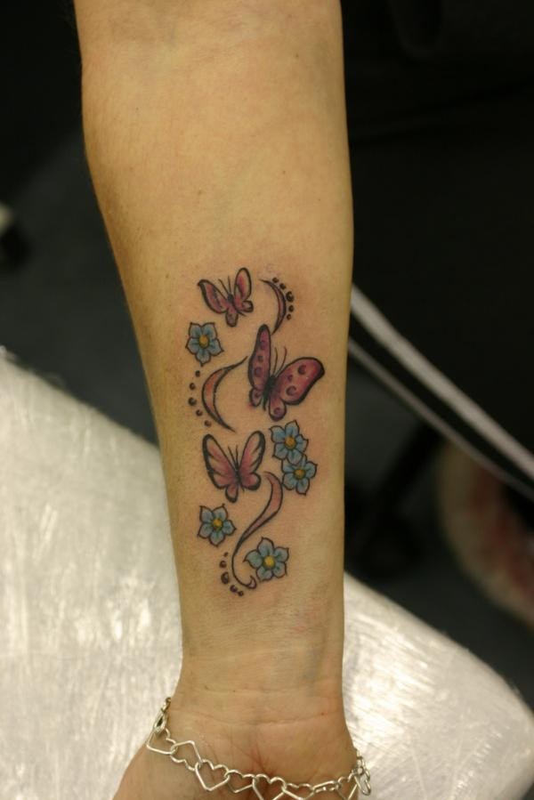 Pink butterflies and flowers tattoo on wrist
