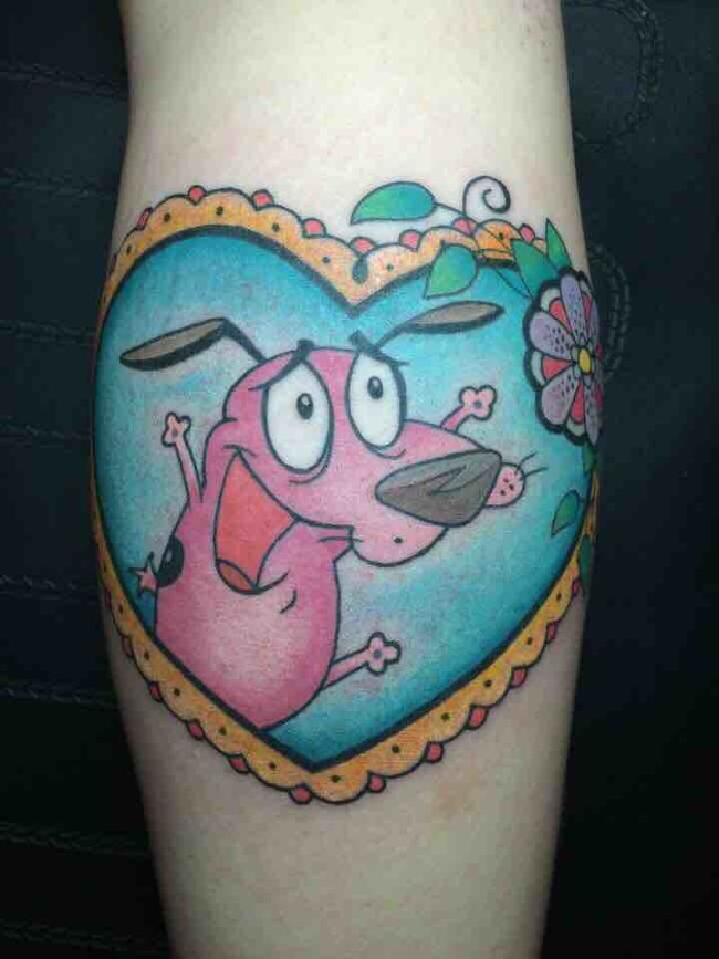 Pink cartoon dog in heart shaped frame bright colored tattoo with flowers