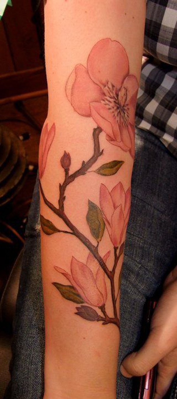 Pink colored illustrative style arm tattoo of big flowers branch