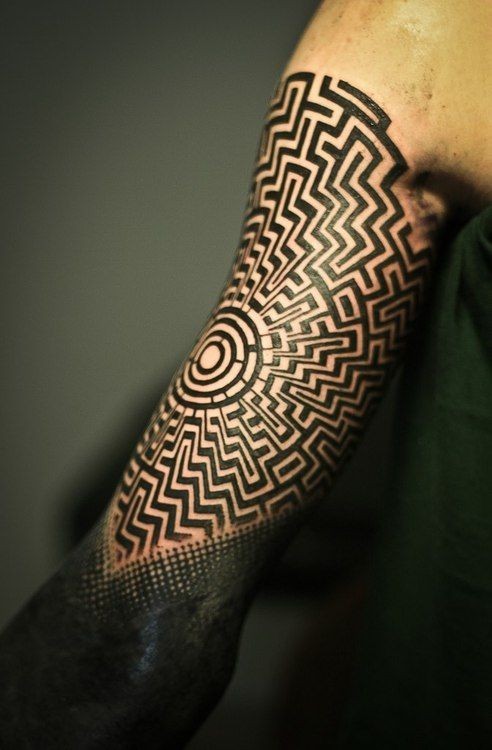 Polynesian style big black and white hypnotic ornament tattoo on arm
