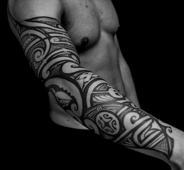 Polynesian style black ink sleeve tattoo of various ornaments