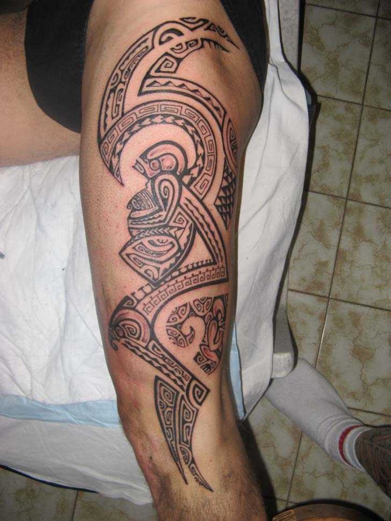 Polynesian style colored tribal ornaments tattoo on arm