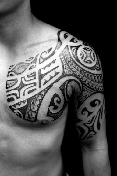 Polynesian tribal style ornament dark black ink tattoo on arm and chest