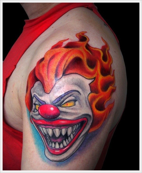 Portrait of a terrible red haired clown tattoo on shoulder