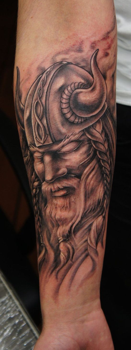 Portrait of harsh viking forearm tatoo