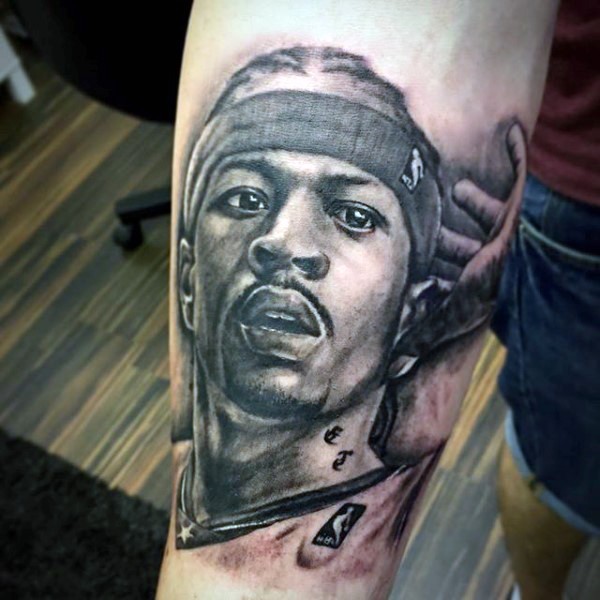 Portrait style black ink basketball player tattoo on forearm