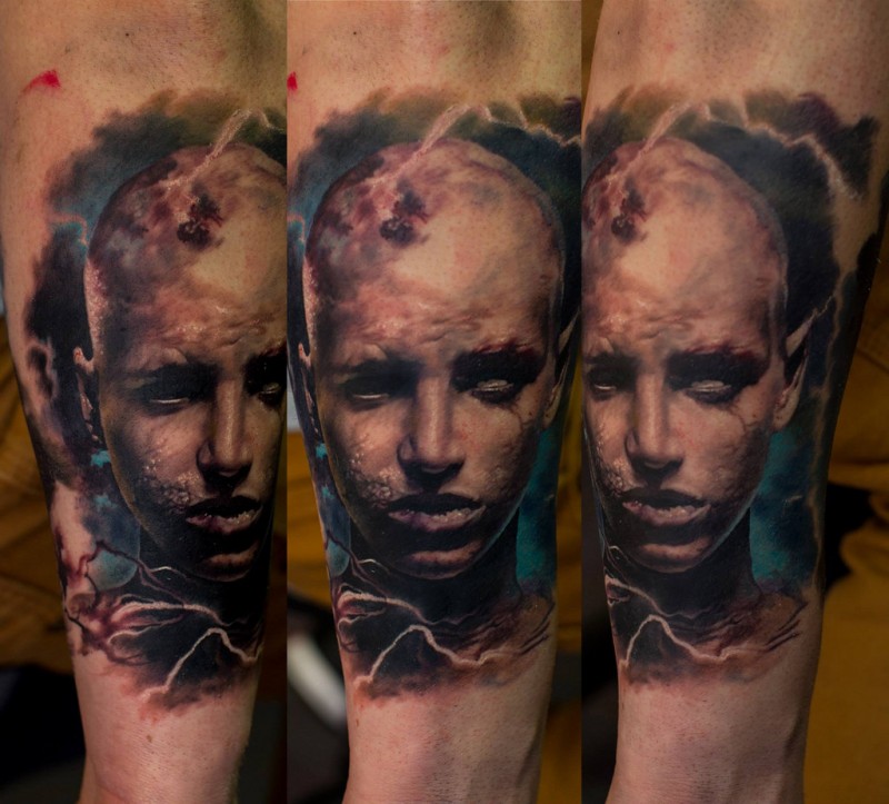 Portrait style colored arm tattoo of human face