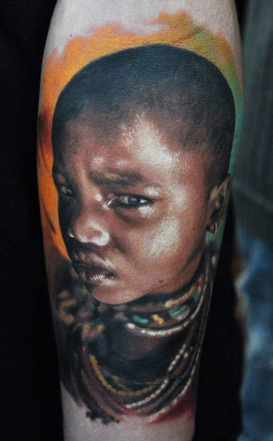 Portrait style colored arm tattoo of tribal girl
