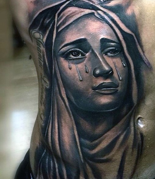 Portrait style colored belly tattoo of crying woman and lettering