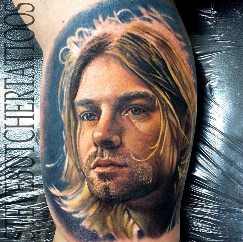 Portrait style colored biceps tattoo of Kurt Cobain