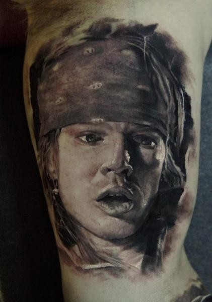 Portrait style colored biceps tattoo of famous singer
