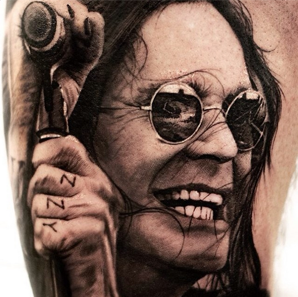 Portrait style colored famous singer face in sun glasses tattoo