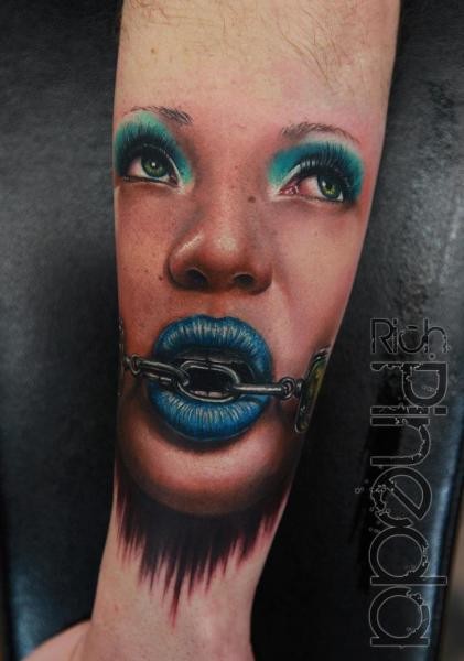Portrait style colored forearm tattoo of woman face with chain