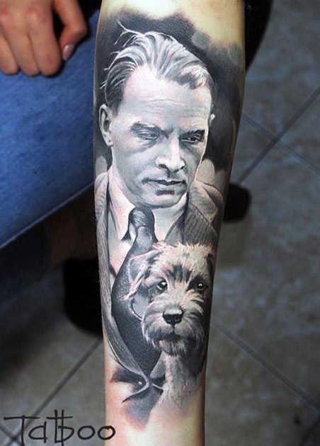 Portrait style colored forearm tattoo of man with little dog