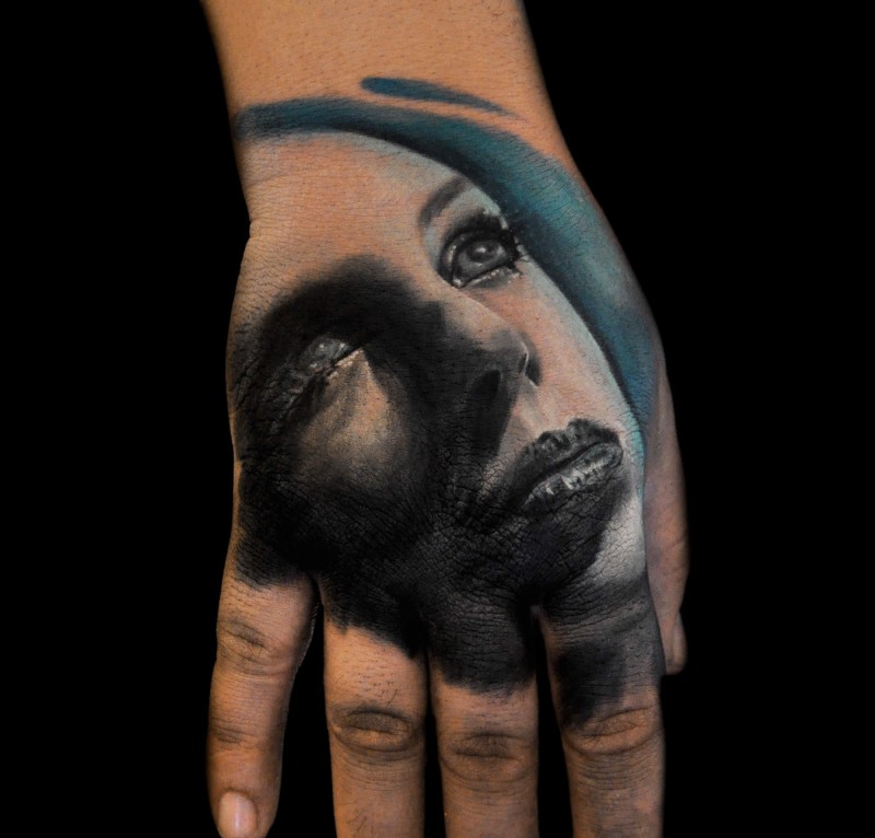 Portrait style colored hand tattoo of beautiful woman portrait