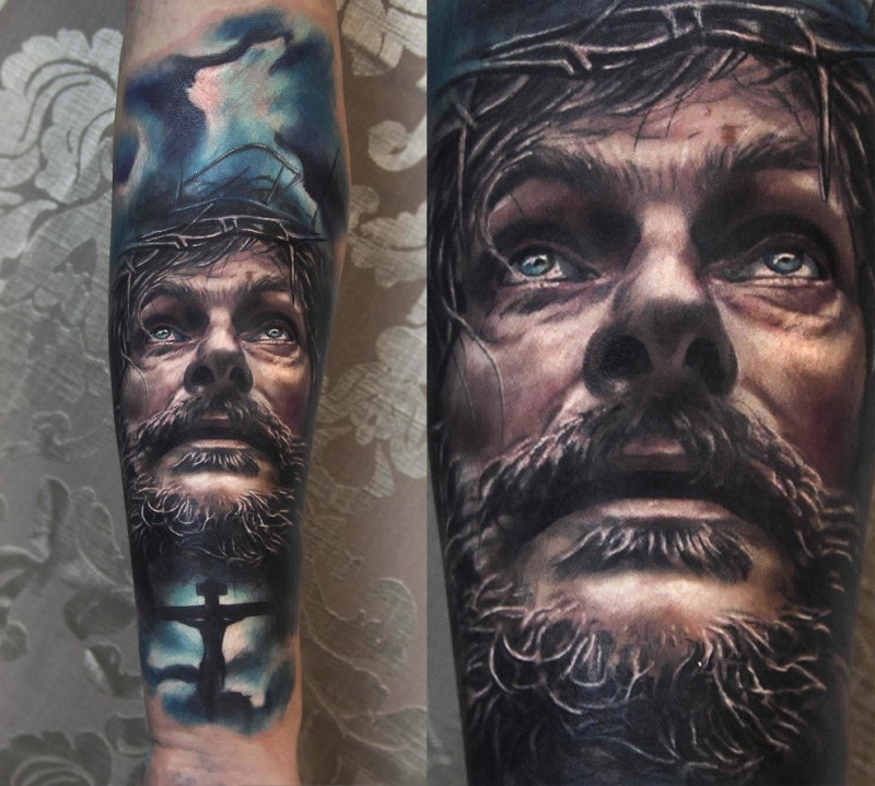 Portrait style colored Jesus face tattoo with dark sky and cross