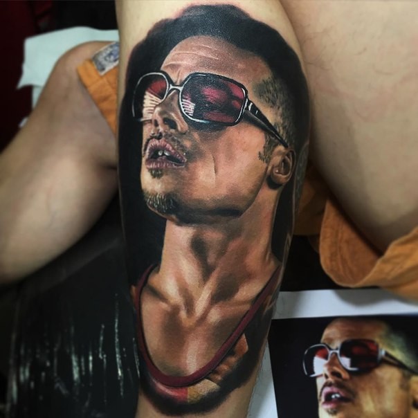 Portrait style colored leg tattoo of awesome looking man with sun glasses