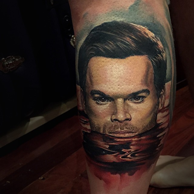 Portrait style colored leg tattoo of bloody Dexter face