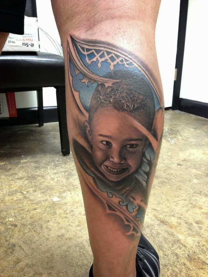 Portrait style colored leg tattoo of little boy face