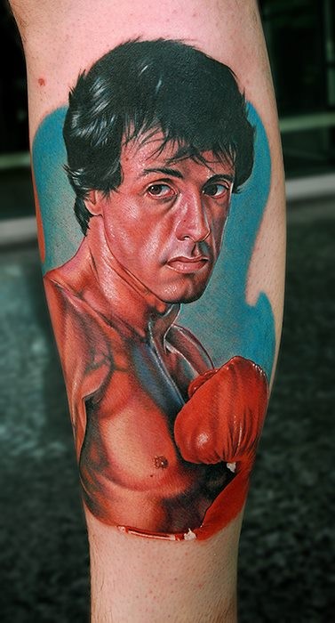 Portrait style colored leg tattoo of Rocky movie hero