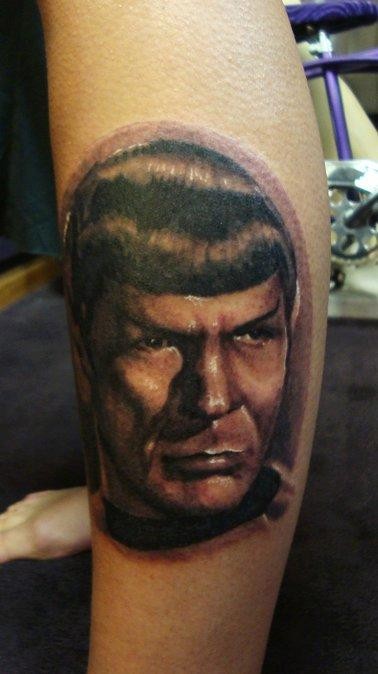 Portrait style colored leg tattoo of Spock