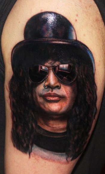 Portrait style colored shoulder tattoo of Slash face