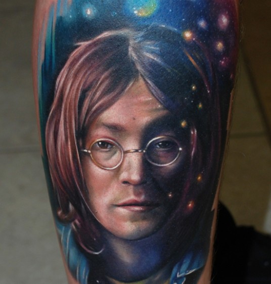 Portrait style colored tattoo of Aron Lennon face