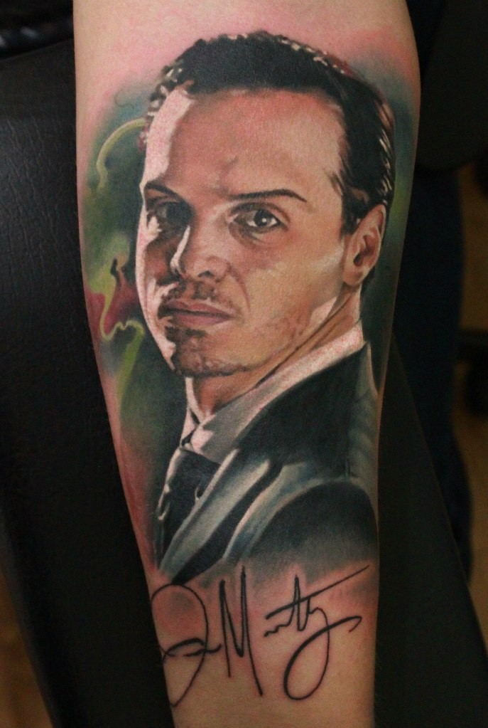 Portrait style colored tattoo of famous man face