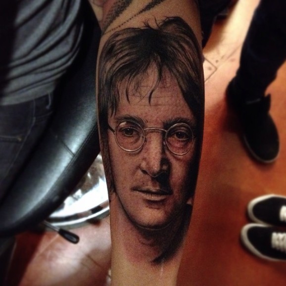Portrait style colored tattoo of Lennon face