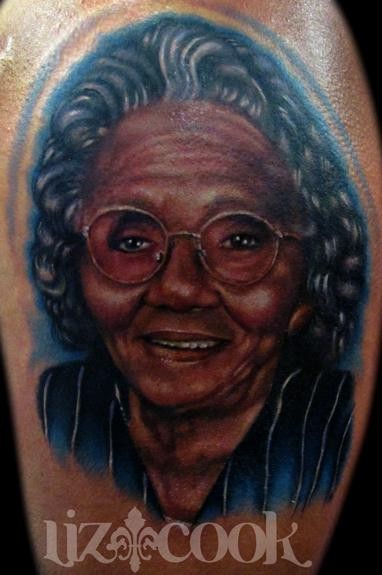 Portrait style colored tattoo of old woman face