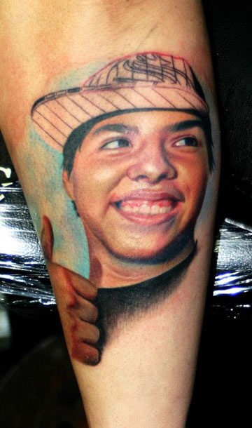 Portrait style colored tattoo of smiling boy face