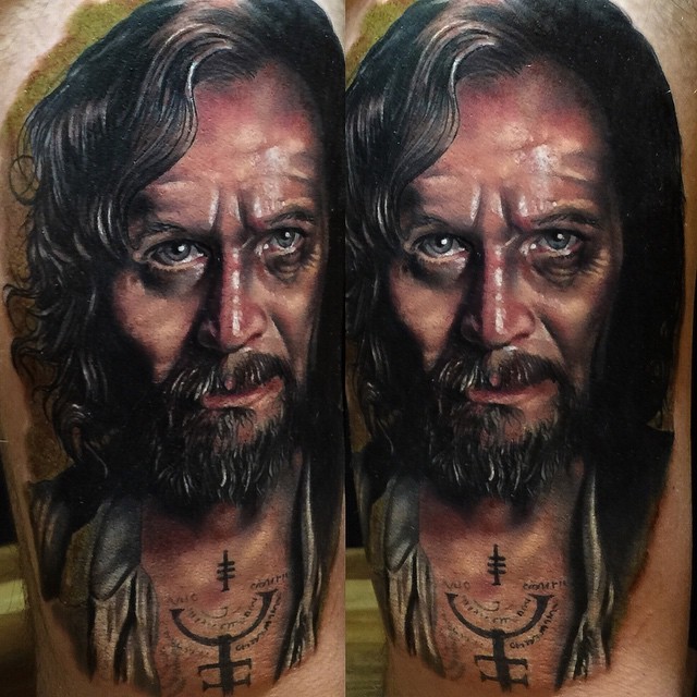 Portrait style colored very detailed tattoo of man face with beard