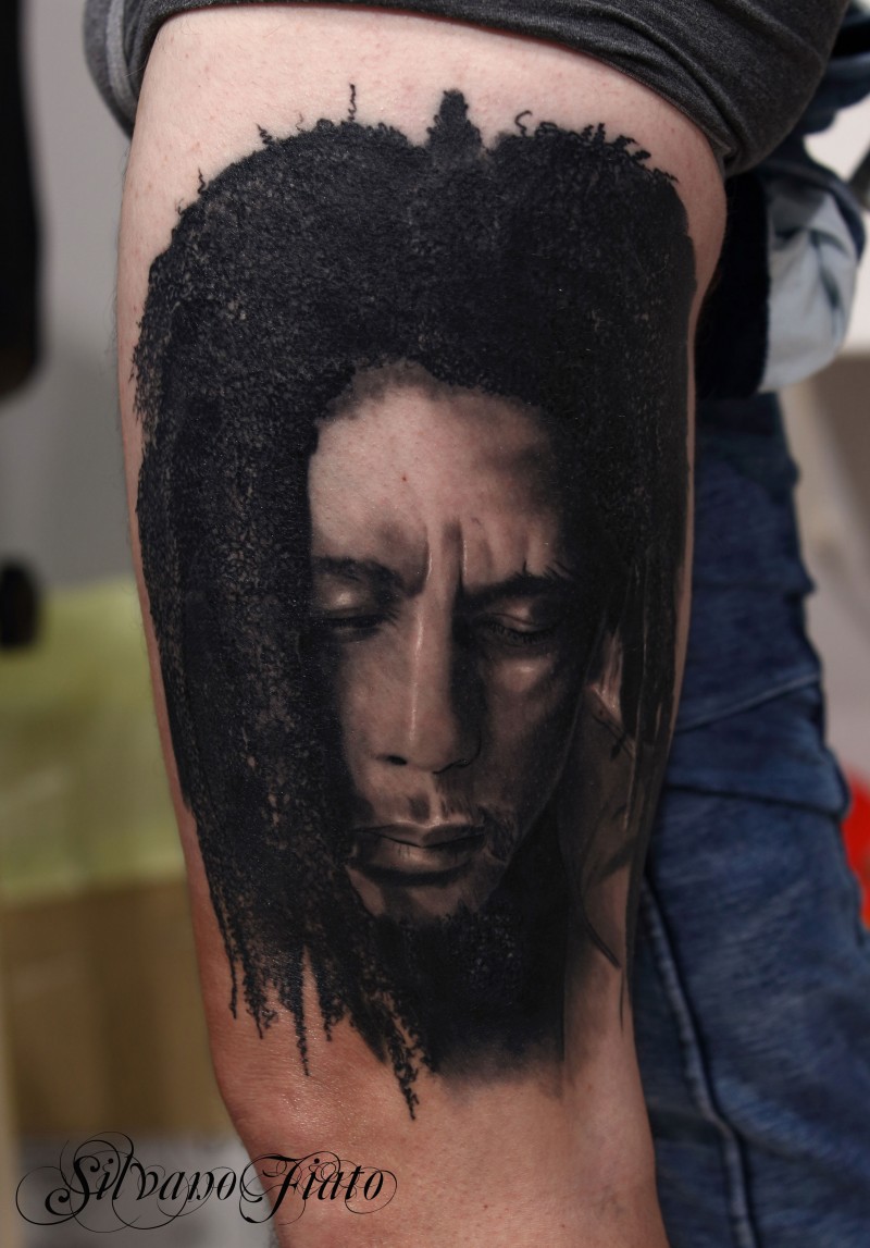 Portrait style detailed arm tattoo of famous musician