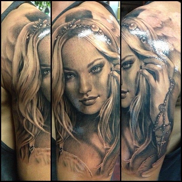 Portrait style detailed beautiful woman face tattoo on shoulder